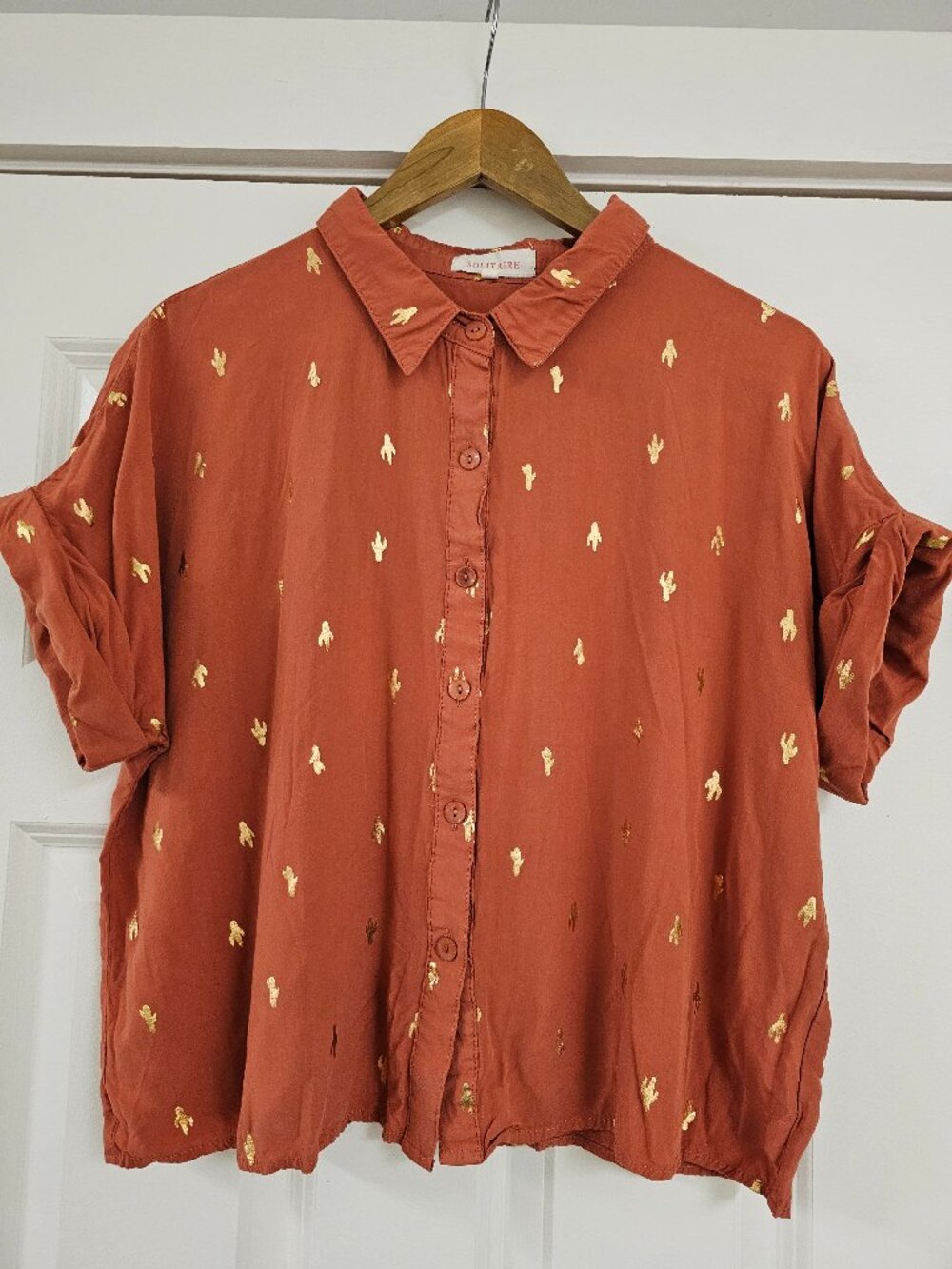 Solitaire Women's button-up cropped shirt in rust orange and gold cactus pattern